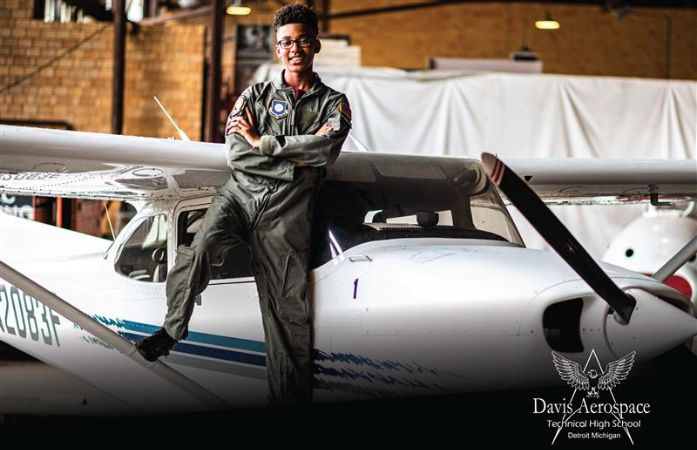  Aviation student leaning against a plane